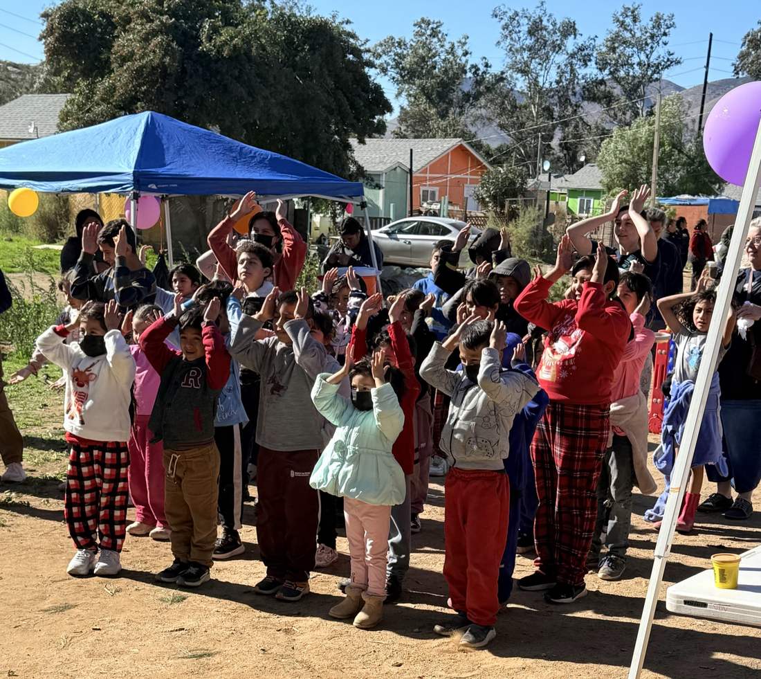 Children celebrating at a Club Dust home dedication in December