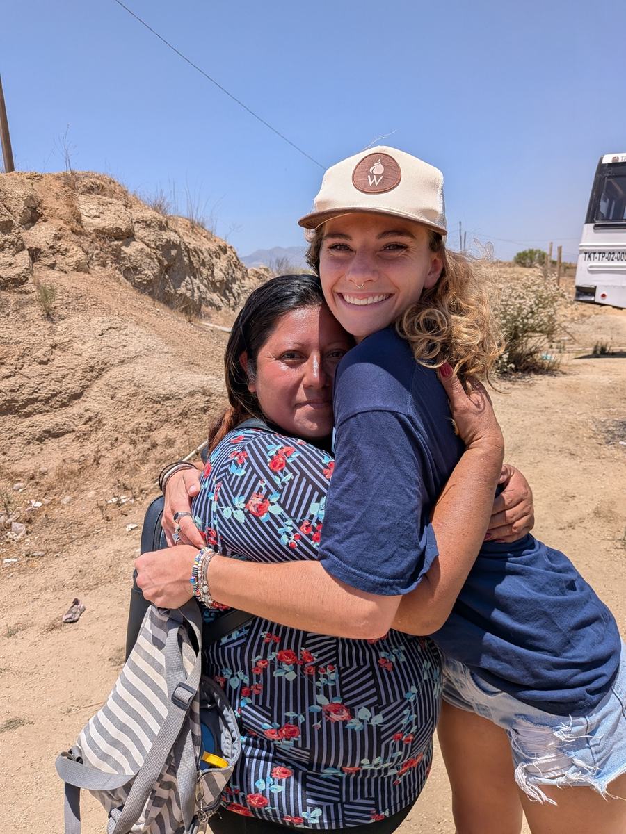 Two volunteers hugging at the end of a build day