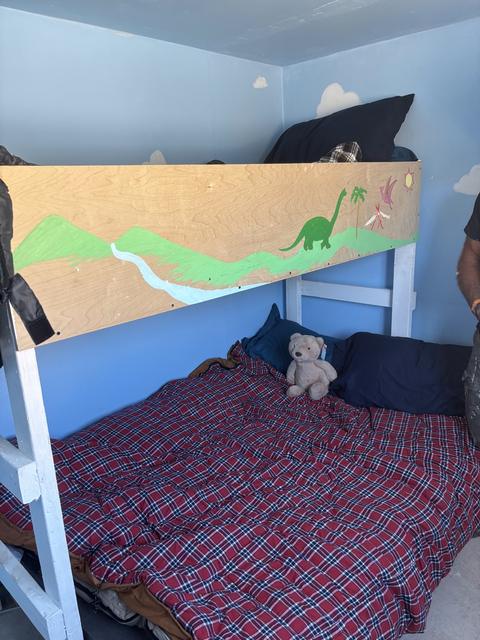 A new bunk bed with a teddy bear waiting